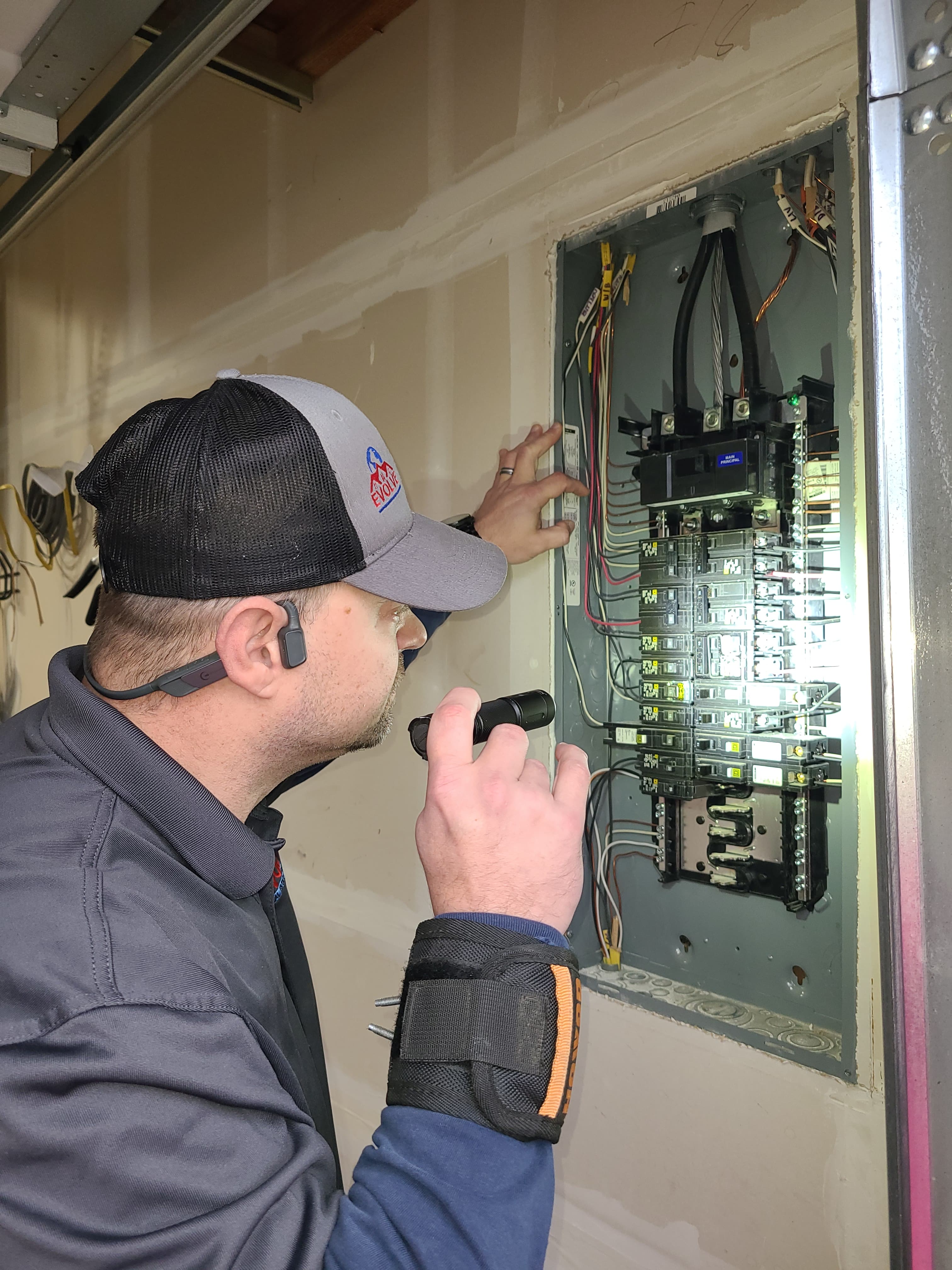 Chris Simpson inspecting electrical panel